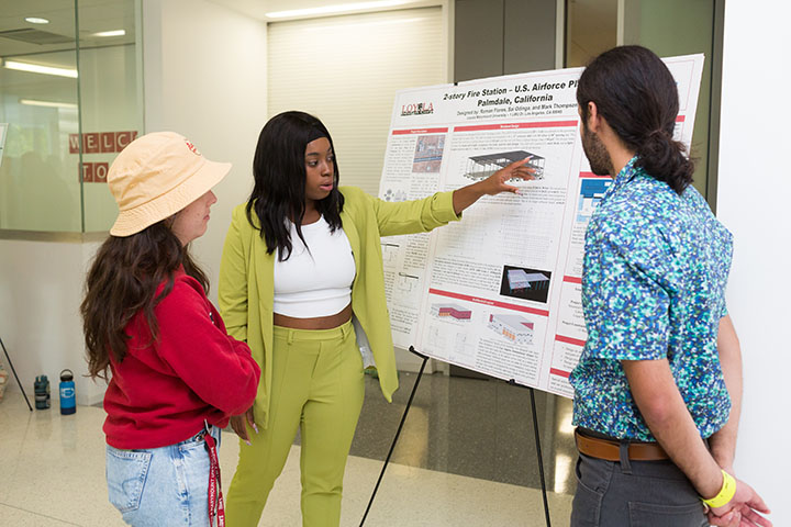 Student explains her project to another person